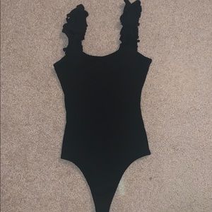 Black ribbed body suit with ruffle straps